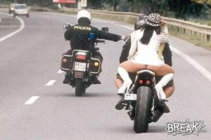 Motorcycle cop pulls over another motorcyle with hot biker chick on the back.